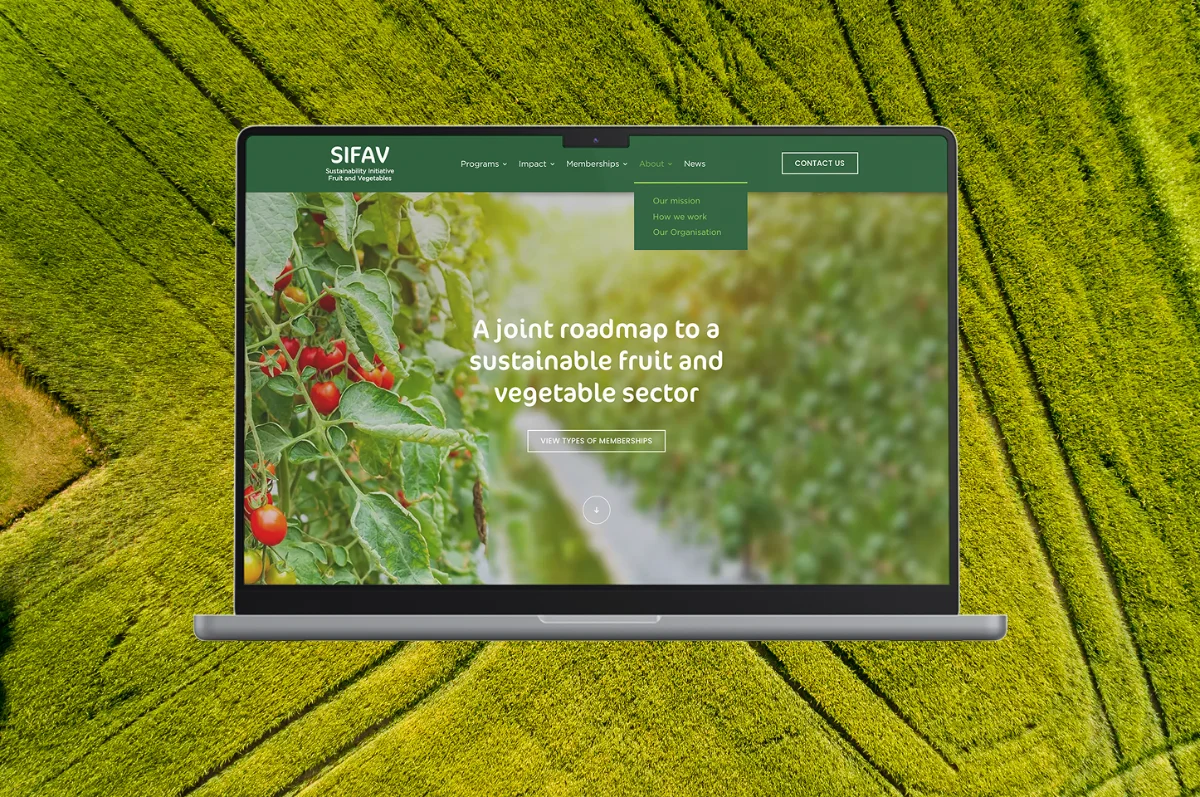 Laptop showing the SIFAV website over a green field