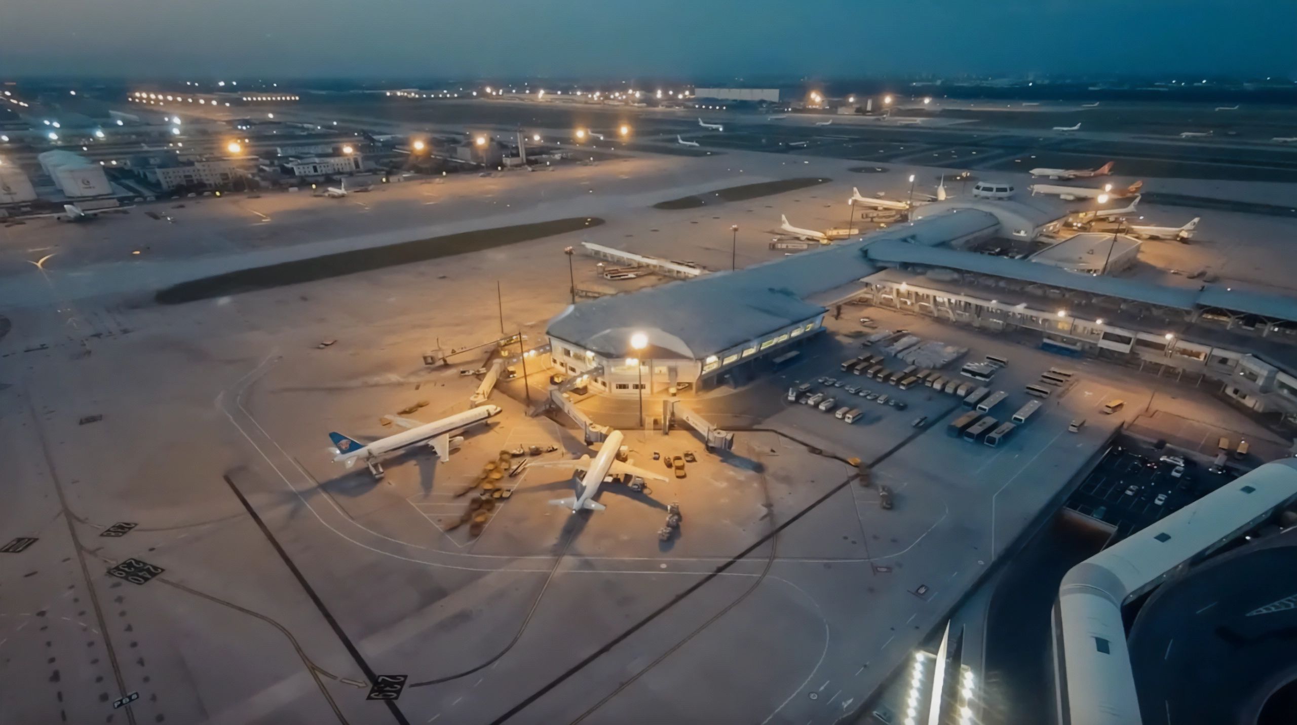 An airport apron at dusk, seen from the air