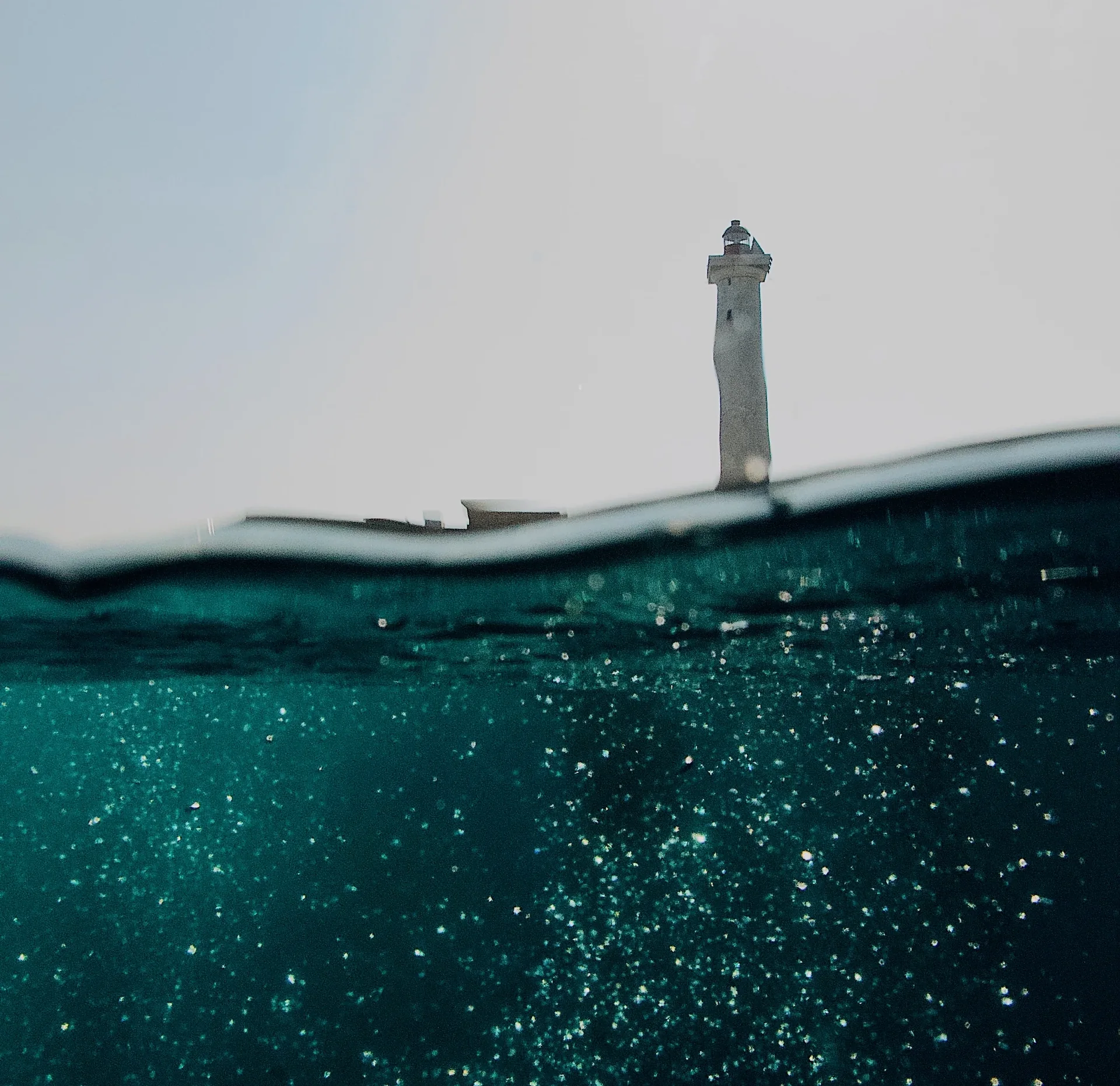 Swimmer by a lighthouse