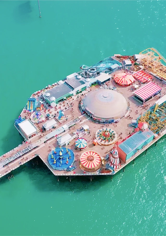 Brighton Palace Pier from the air, ringed by turquoise sea