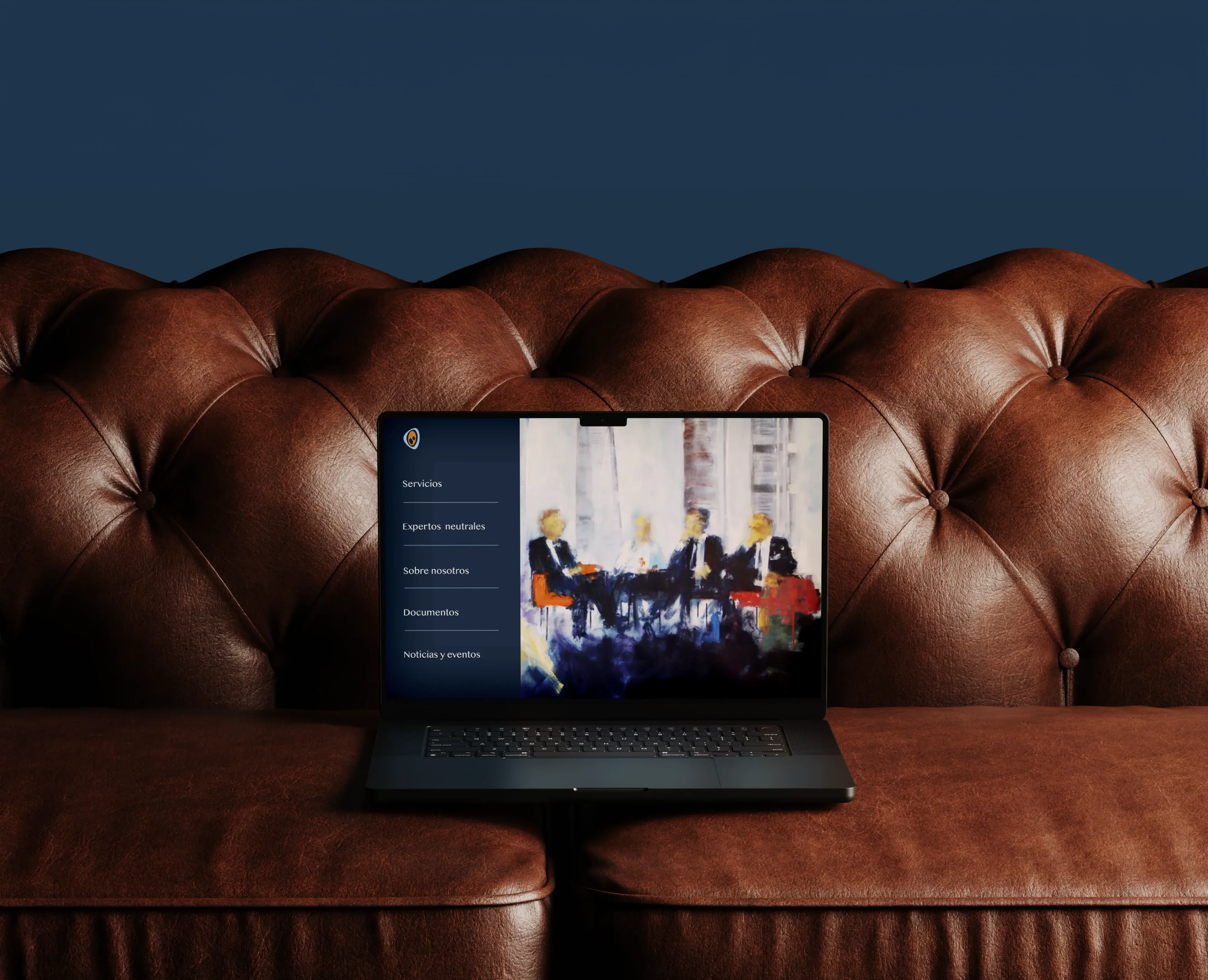 The cmfide.com homepage open on a laptop resting on a leather Chesterfield sofa