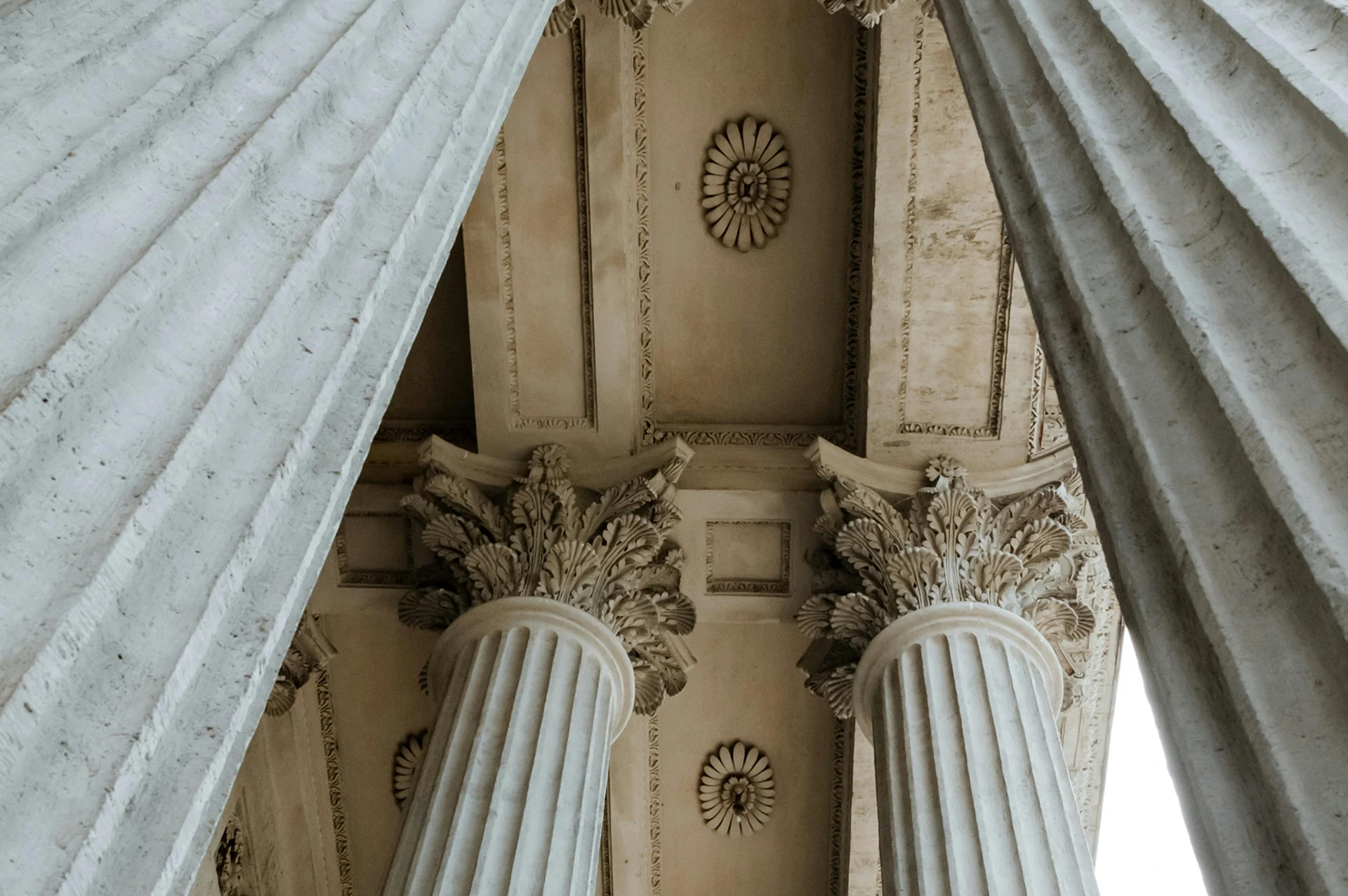 Corinthian capitals seen from below, the brand's visual motif