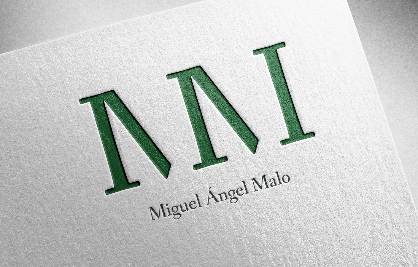 The monogram embossed on white stock