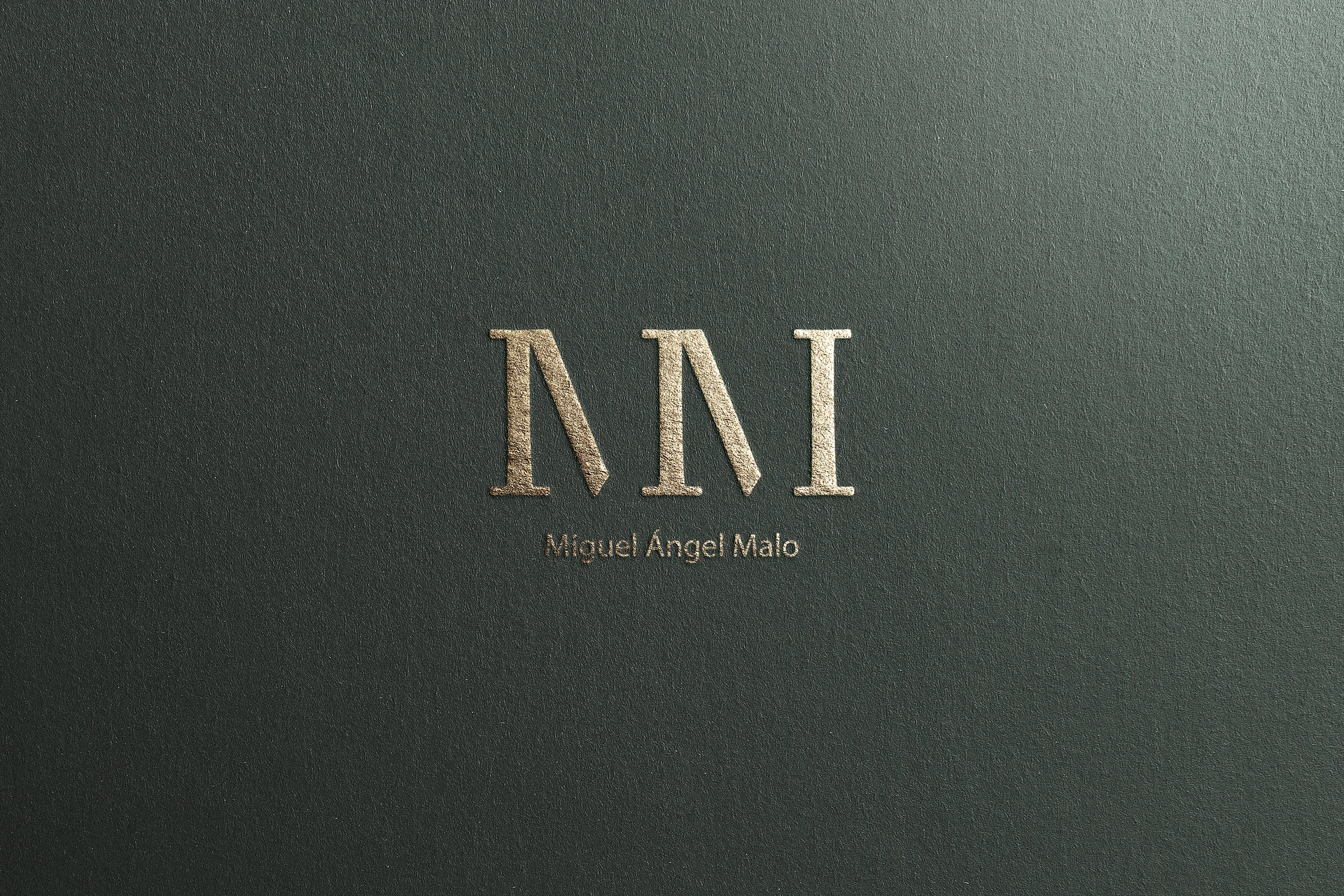 The monogram foil-blocked on dark green paper