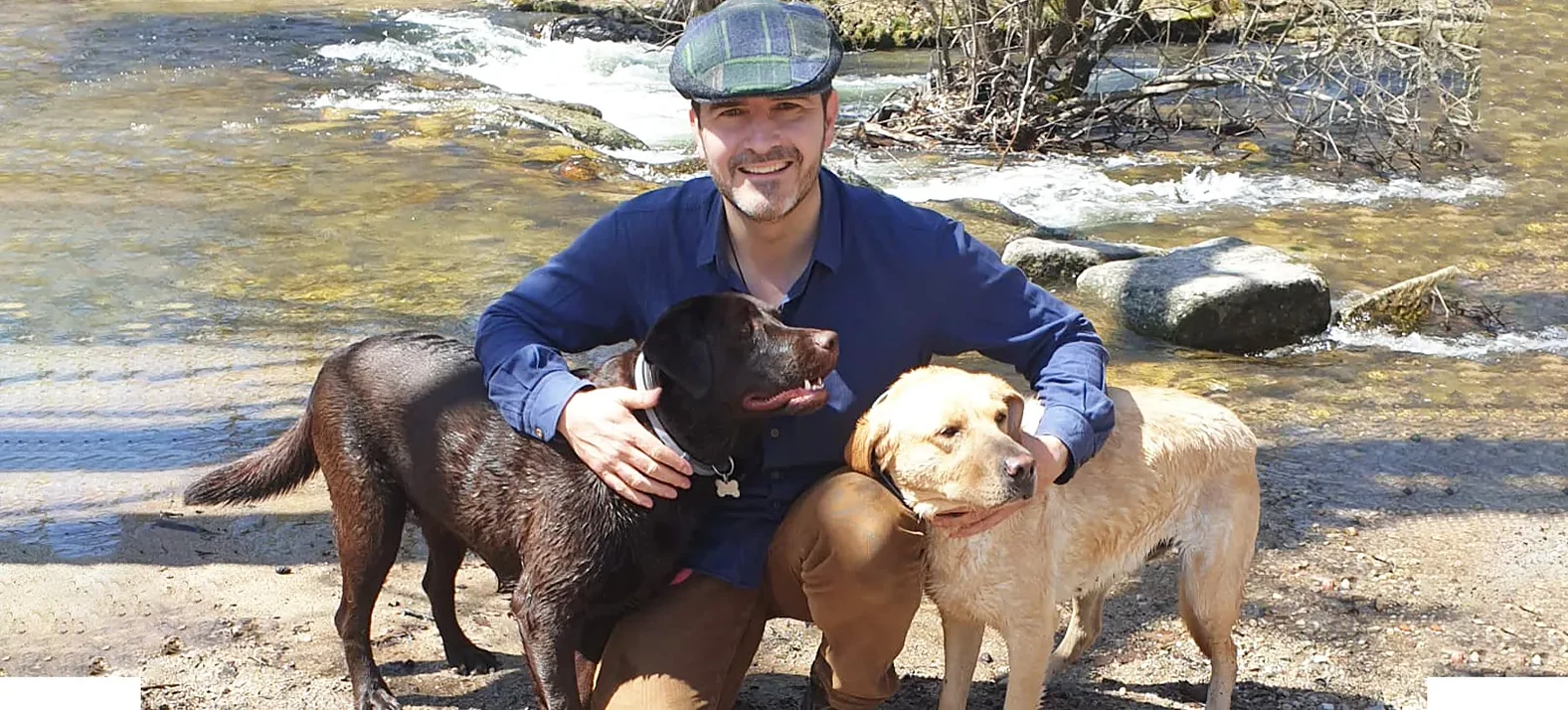 Miguel Ángel Malo outdoors with two dogs