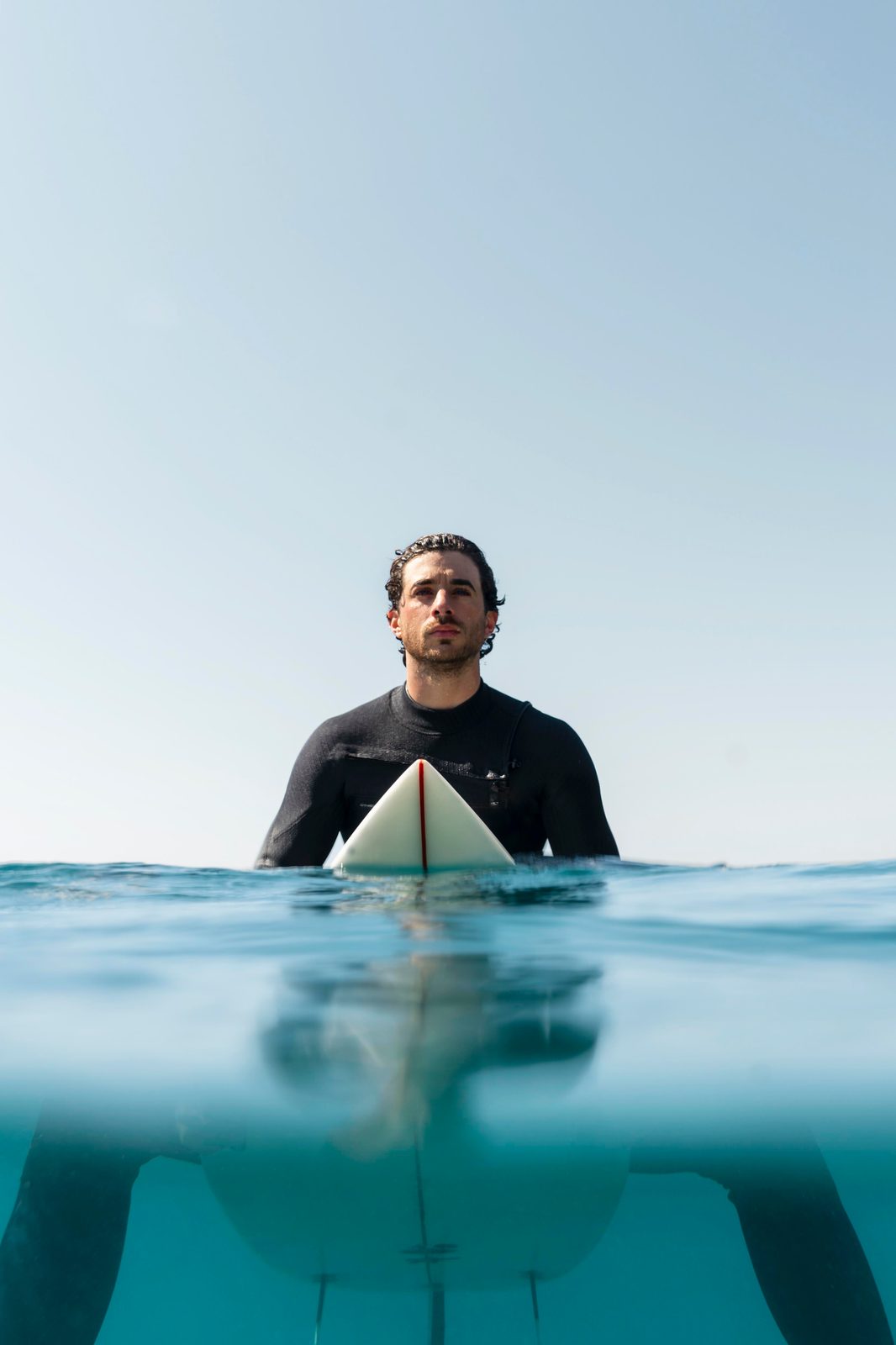 Surfer walking into the sea